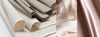 Echalandage de tissus issus de fibres de bananiers de couleurs écrus et bois de rose.