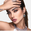 Boucles d'oreilles pierre topaze bleu ciel sur un visage de femme brune cheveux longs