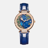    Montre femme acier inoxydable et doré boitier rond représente la tête d'un paon magnifique bracelet acier doré et cuir bleu de france