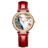    Montre femme acier inoxydable et doré boitier rond représente la tête d'un paon magnifique bracelet acier doré et cuir rouge